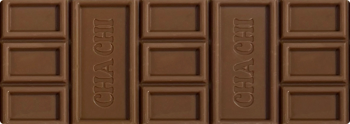 Een uitgepakte CHACHI-reep van melkchocolade, met de naam CHA CHI in twee van de blokken